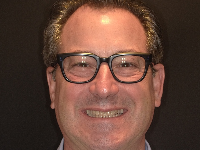 Adult male patient with glasses smiling at Vaccaro Aesthetic and Family Dentistry, Green Village, NJ